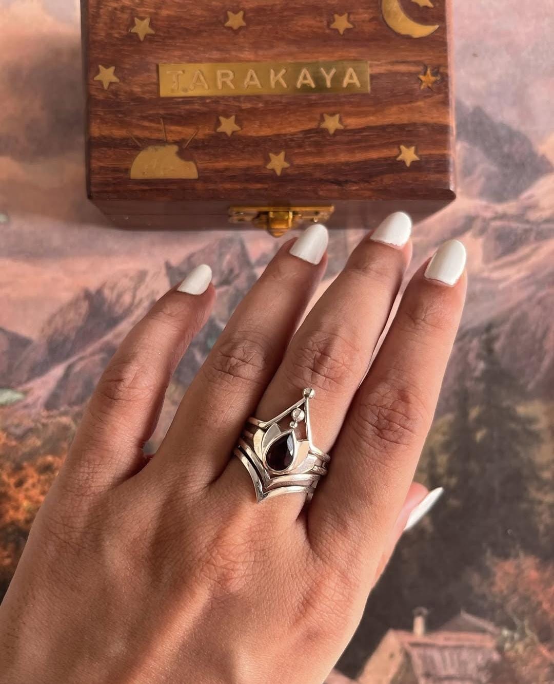 Elegant garnet and lotus sterling silver ring stack