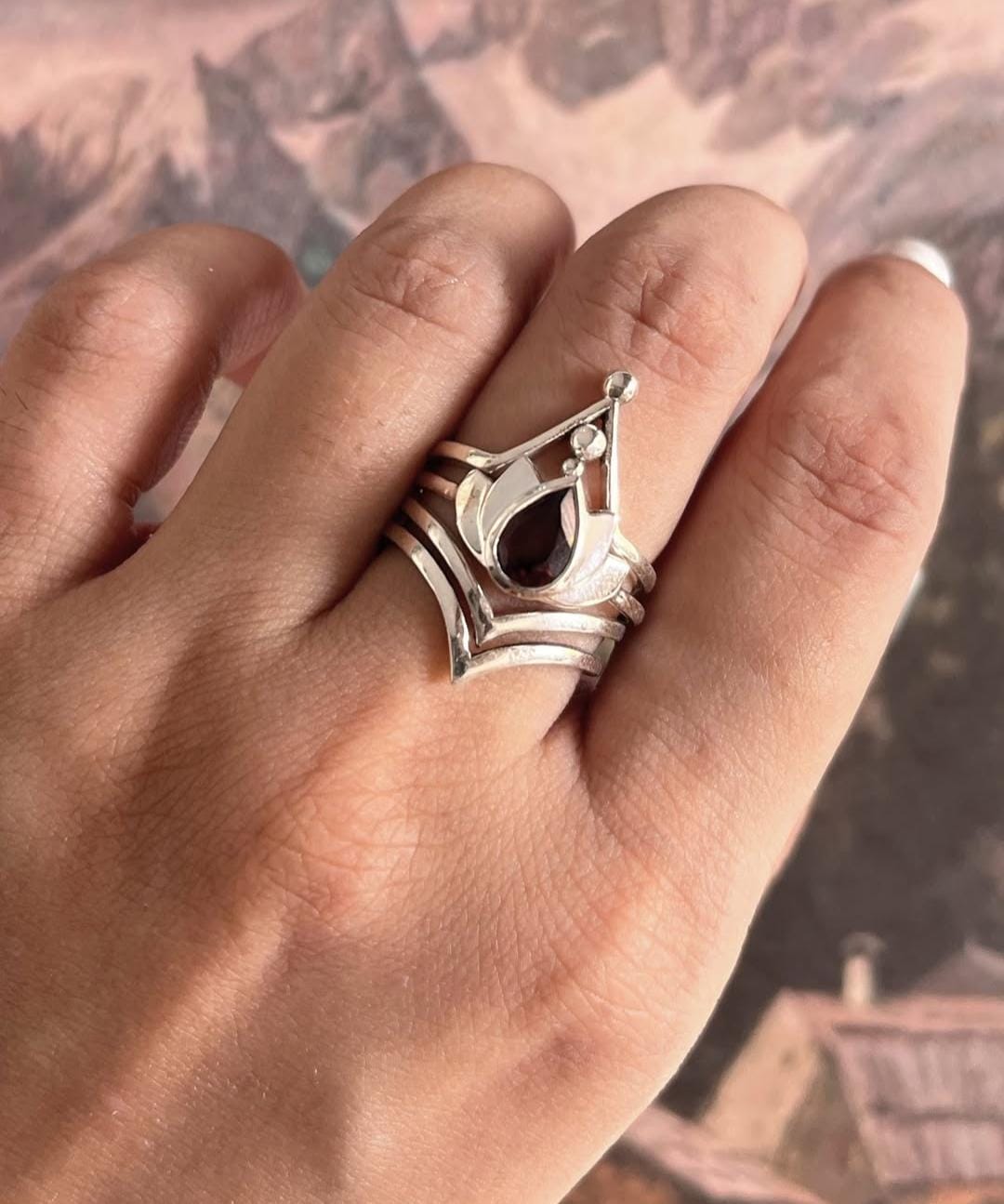 925 sterling silver ring set with garnet and lotus motifs