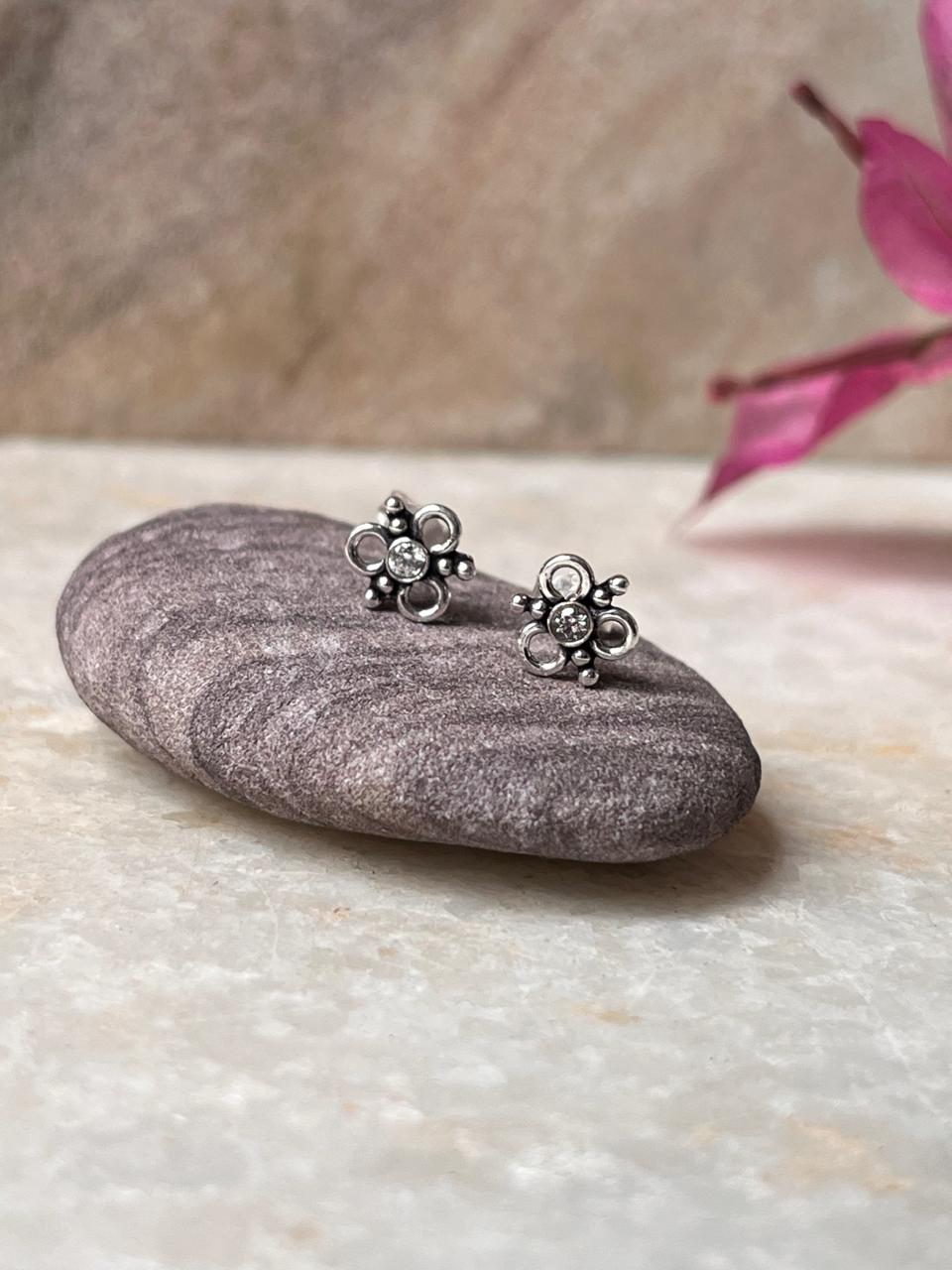 Handcrafted silver flower studs with white cubic zirconia