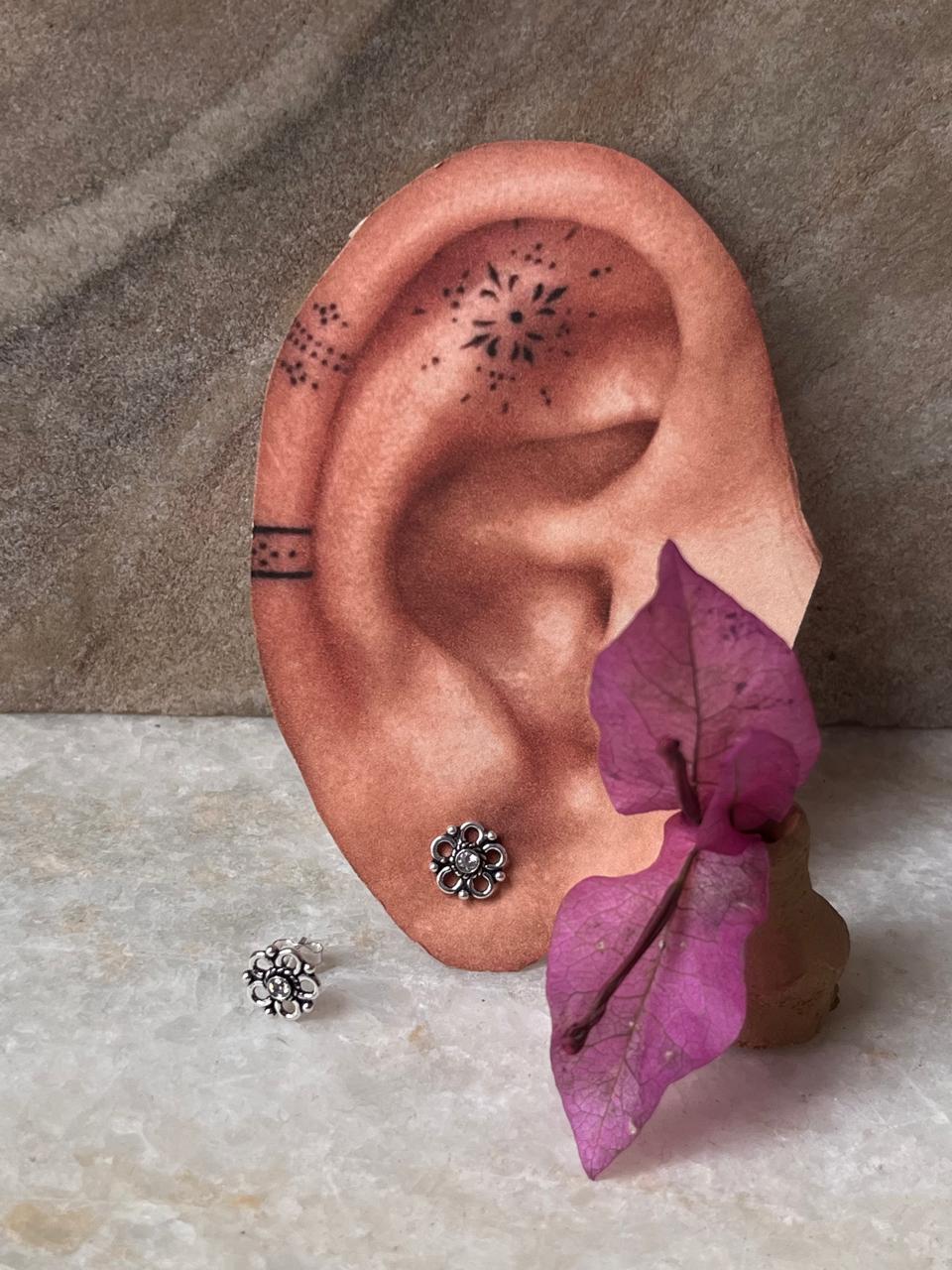 Dainty flower-shaped white CZ studs in sterling silver