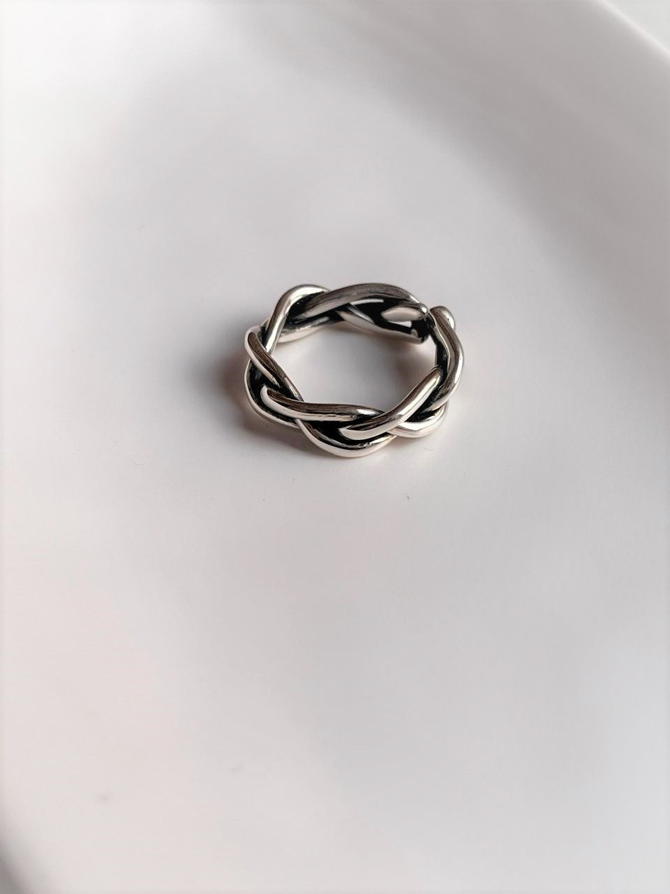 Adjustable handcrafted silver ring with a chunky twisted braided pattern
