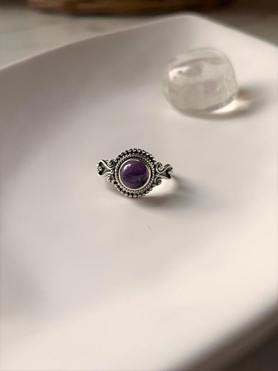 Boho silver ring with a vibrant round amethyst center.