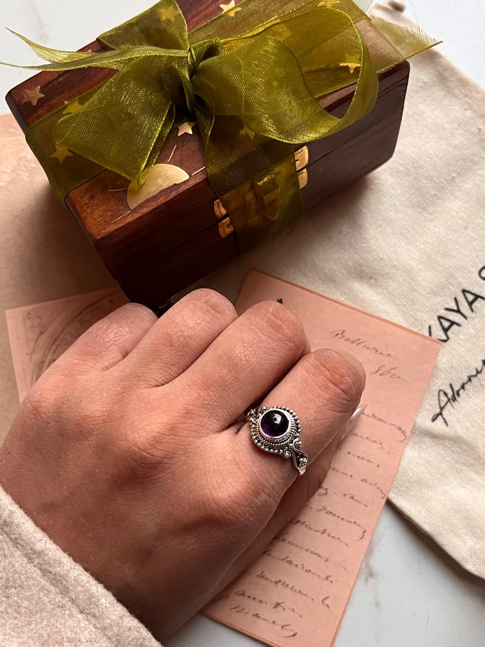 Silver ring with a round amethyst stone, perfect for boho style.