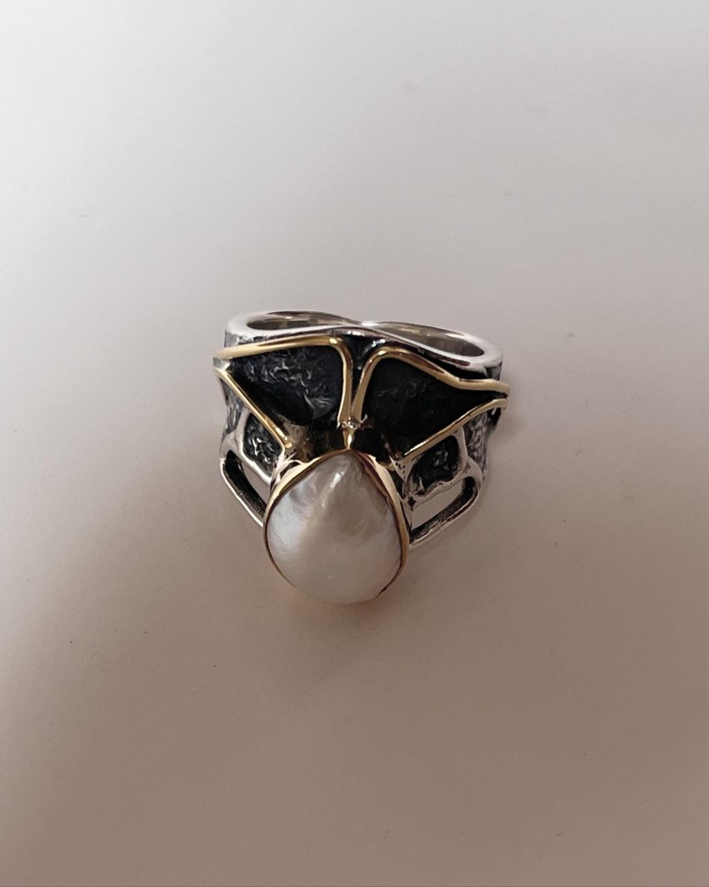 Two Baroque pearls set in a rustic 2 silver ring for a timeless design.