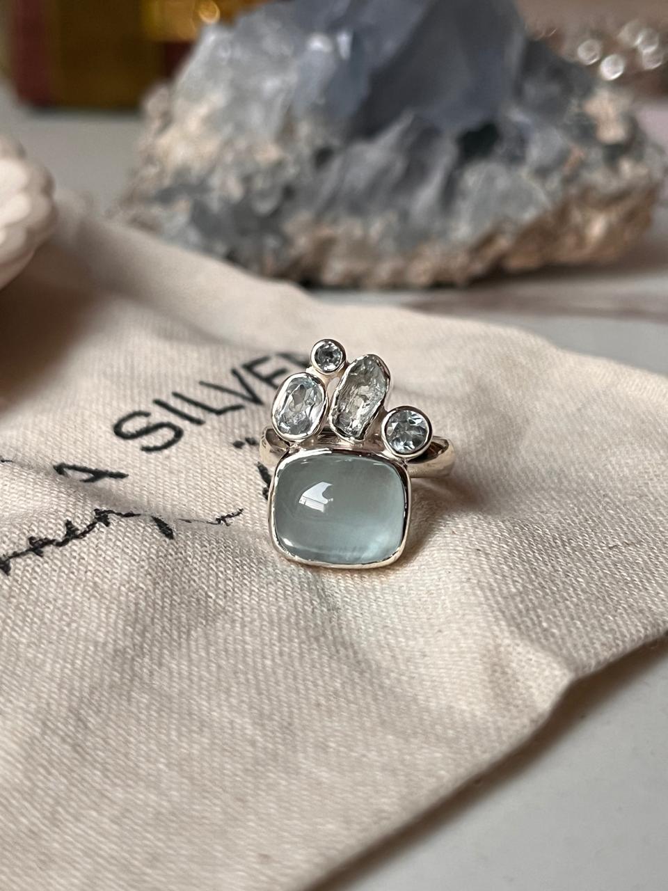 Elegant single aquamarine and blue topaz cluster ring in silver