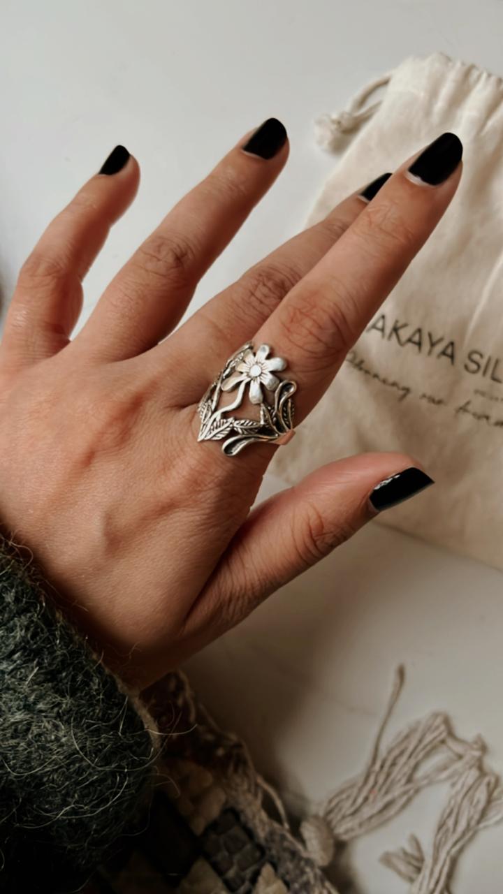 Elegant chunky silver ring featuring a detailed floral garden pattern.
