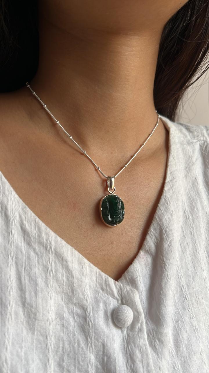 Sterling silver pendant featuring a carved green jade Ganesh