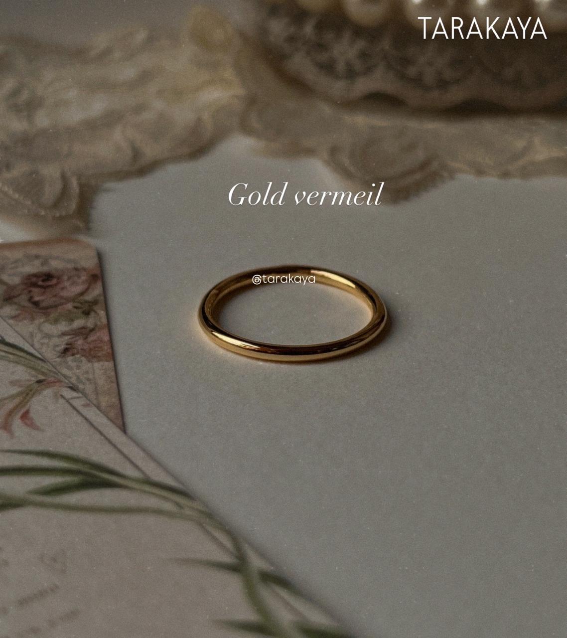 Gold vermeil plain round stack band ring on soft background, showcasing its elegant design and durability.