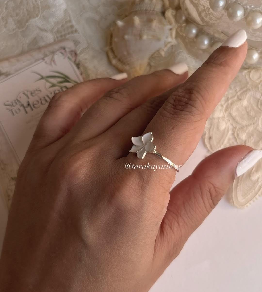 Minimal silver ring with white enamel plumeria flower