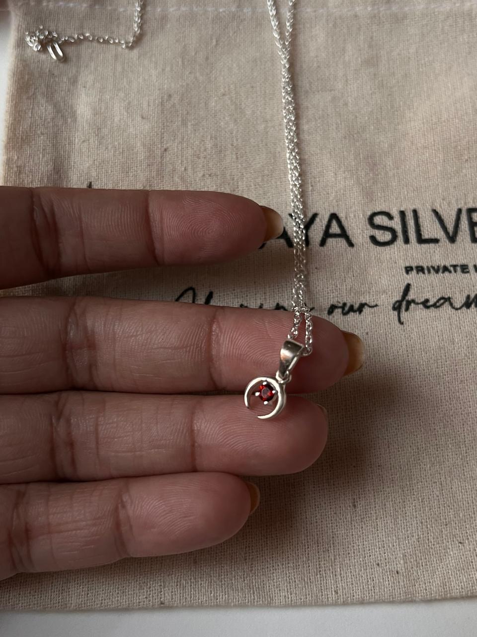 Small crescent moon necklace with garnet charm in silver