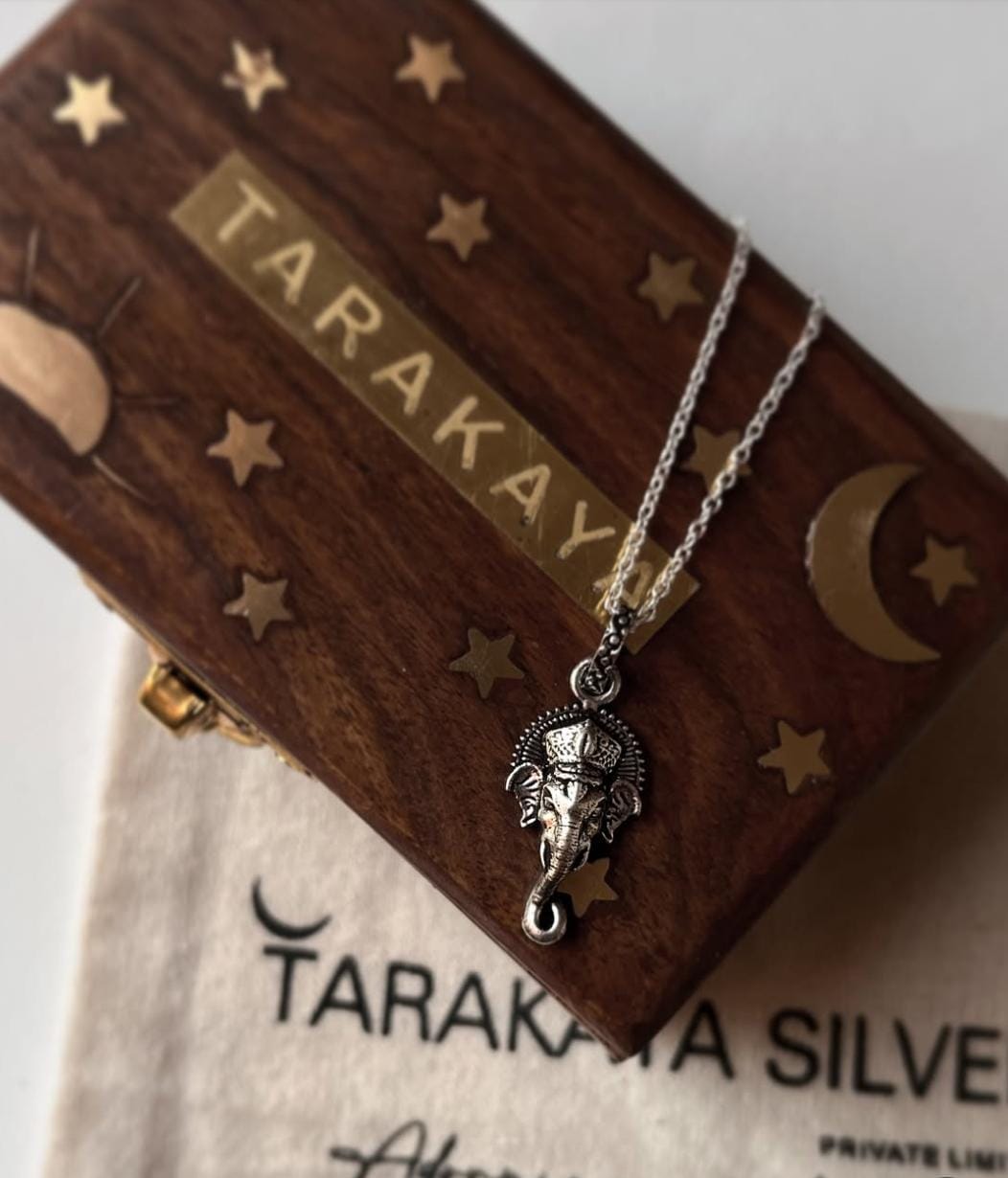 Ganesha face big silver pendant on a wooden box with stars, perfect for unique gifts and special occasions.