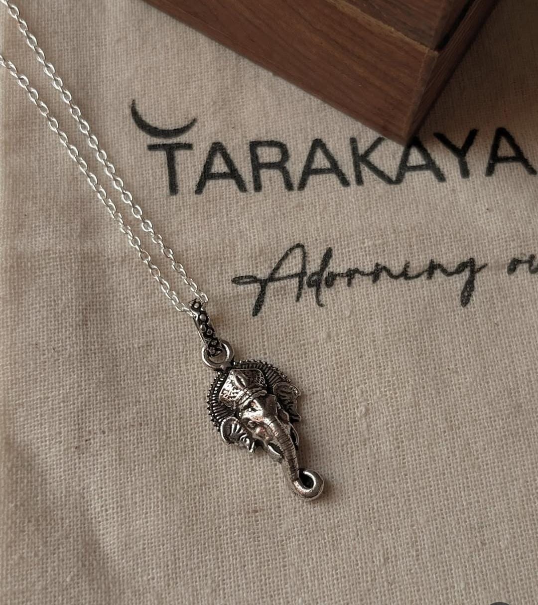 Big silver Ganesha face pendant on a chain, perfect for unique gifts and special occasions.