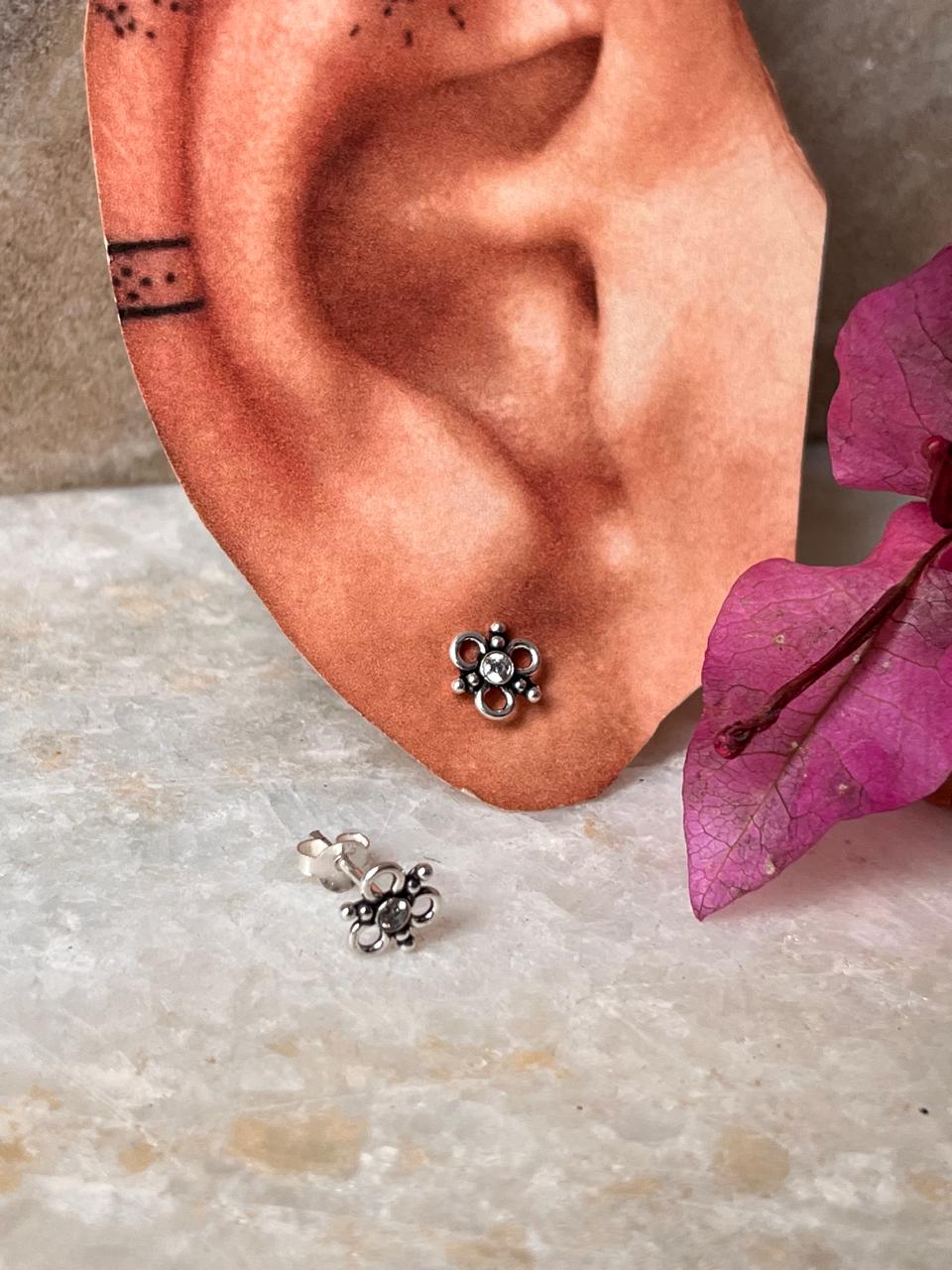 Elegant sterling silver floral stud earrings with white CZ