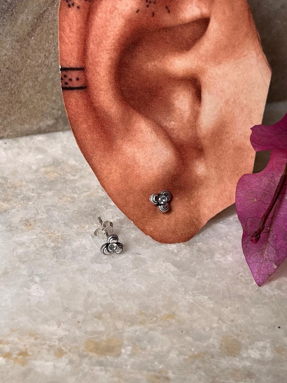Dainty flower-shaped sterling silver studs with white CZ
