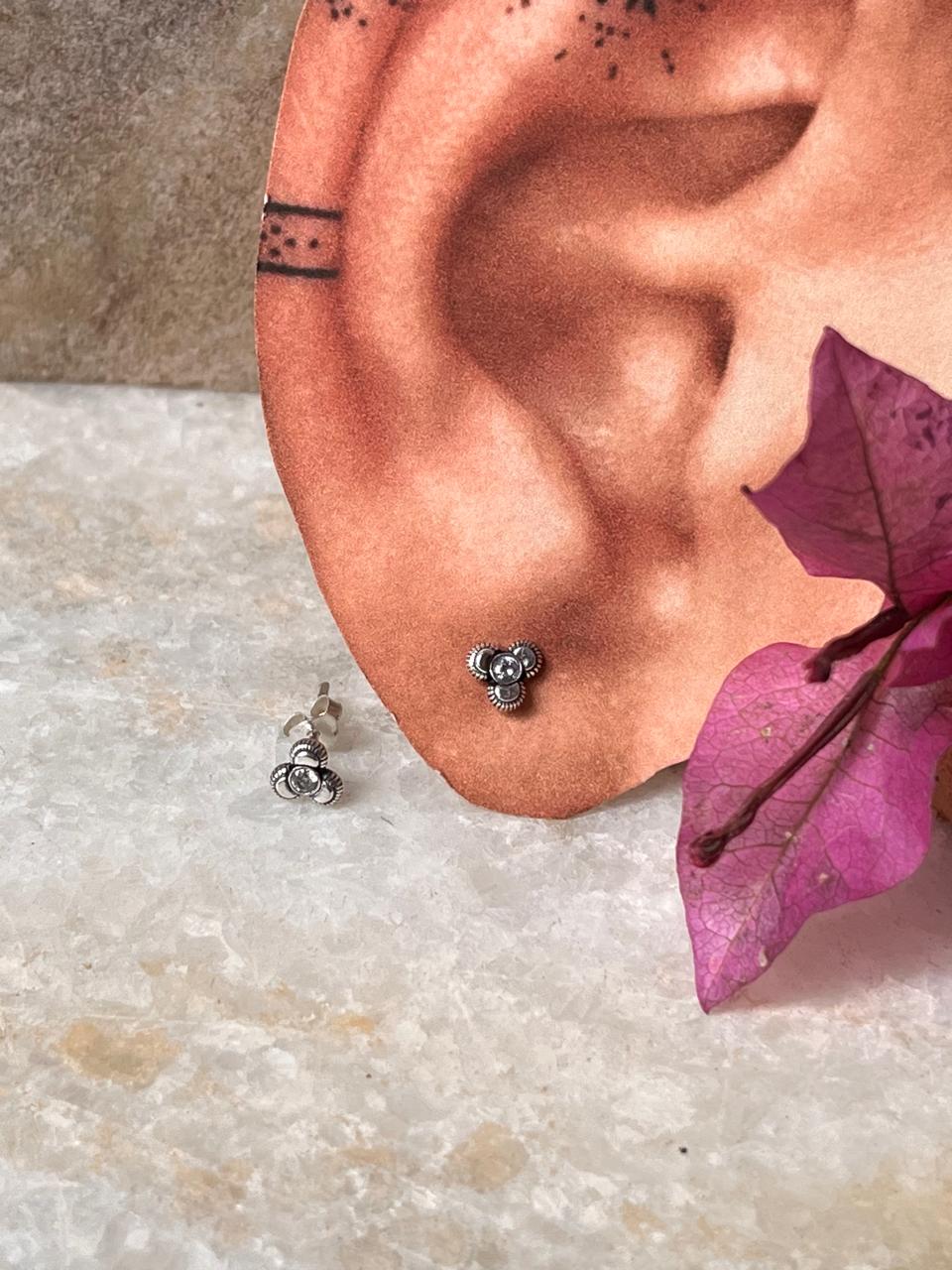 Elegant sterling silver floral stud earrings with white CZ stones