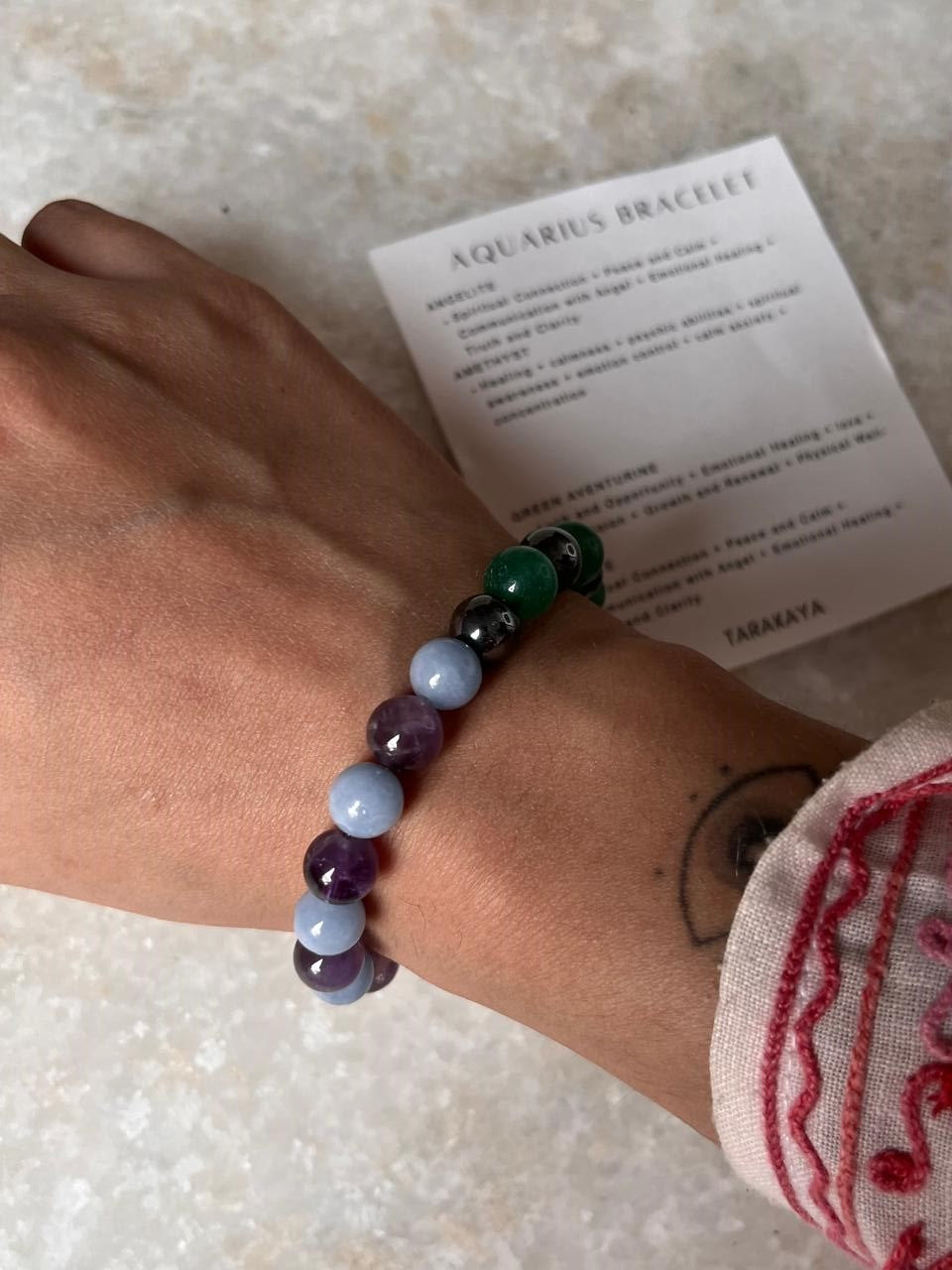 Zodiac-themed Aquarius bracelet with energy crystal
