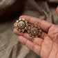 925 Sterling Silver Gold Plated Antique Moissanite Polki Earrings held in hand, showcasing floral elegance.