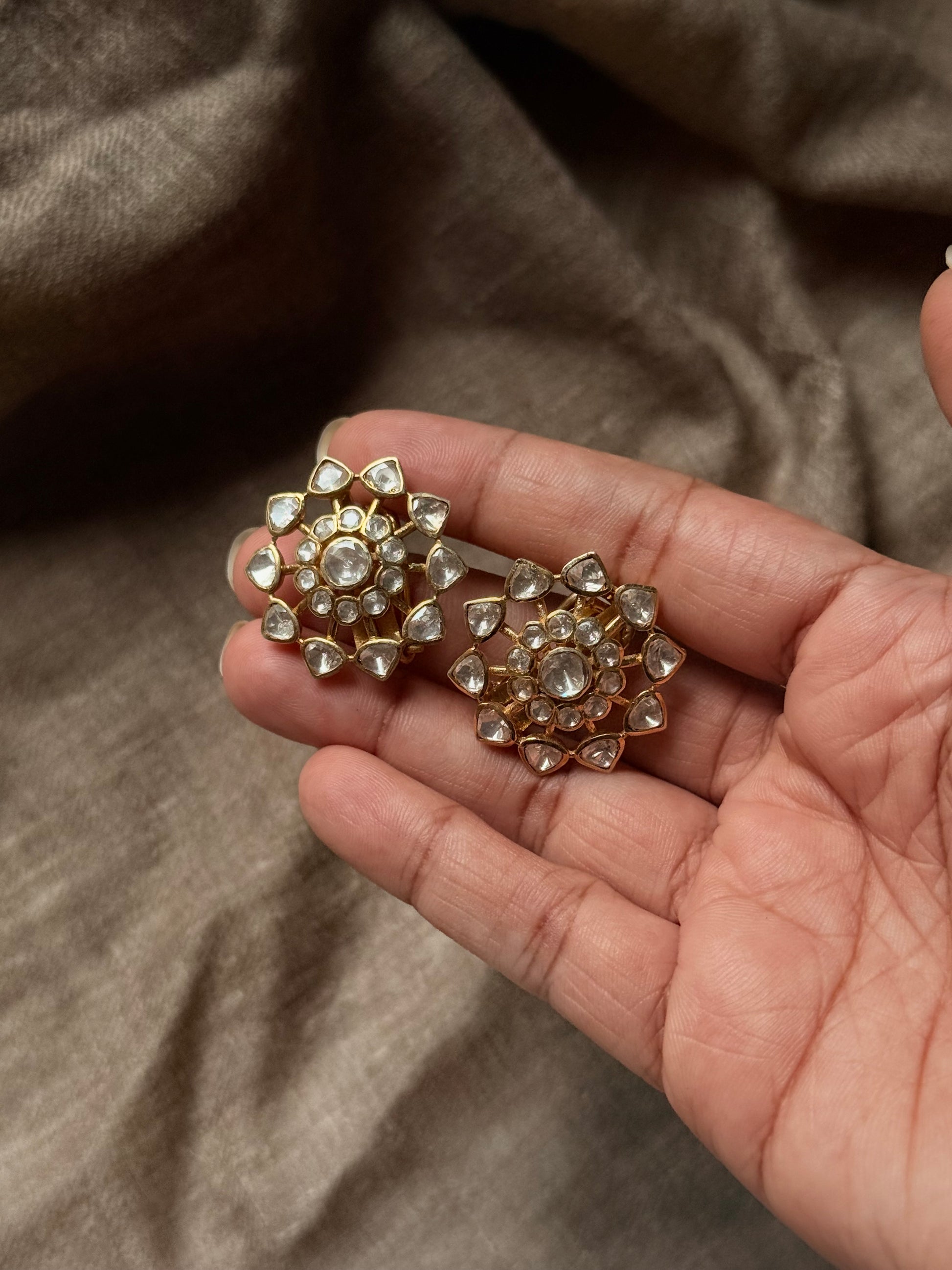 925 Sterling Silver Gold Plated Antique Moissanite Polki Earrings held in hand, showcasing floral elegance.