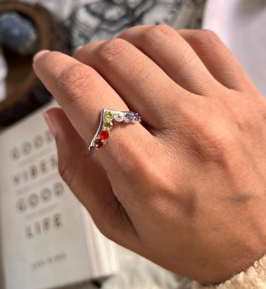 Unique V-shaped silver ring with seven chakra gemstone detail