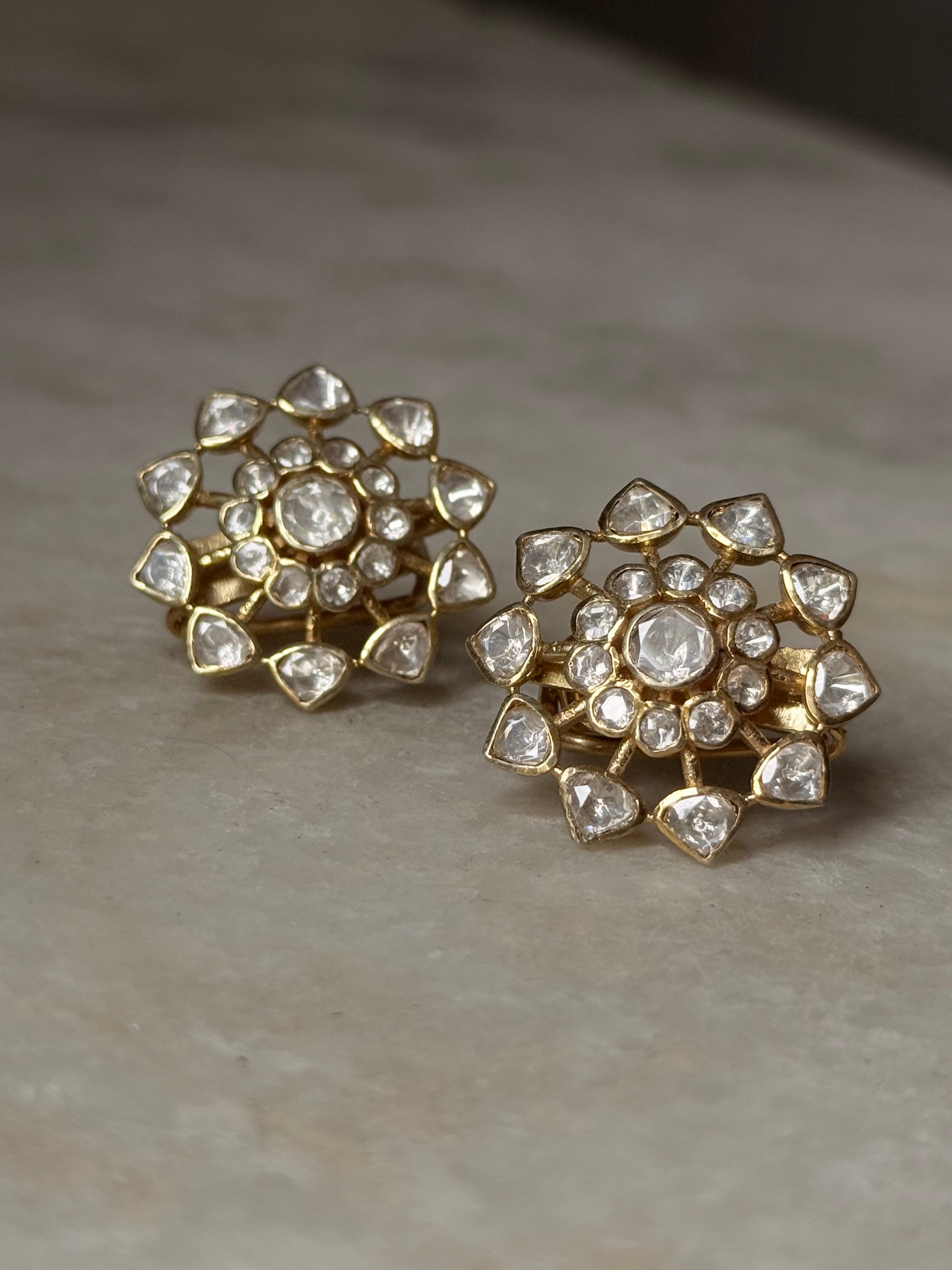 925 Sterling Silver Gold Plated Antique Moissanite Polki Flower Studs Earrings on marble background