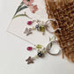 Peridot, pink tourmaline, and pearl charm hoops with floral and butterfly accents