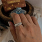 Chunky silver ring featuring a unique croissant-shaped band