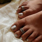 Elegant wavy Rawa design toe ring in pure silver with antique finish.