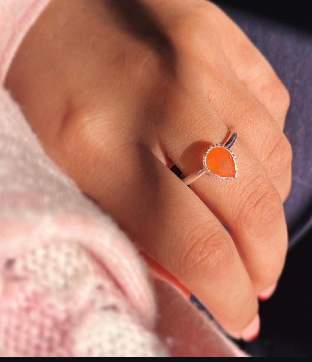 Elegant silver ring featuring a pear-shaped carnelian gemstone