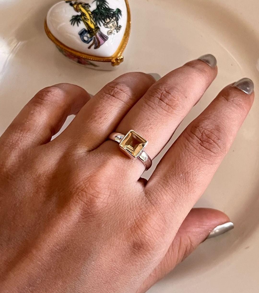 Close-up of citrine square cut gemstone set in a silver ring