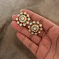 Hand holding 925 Sterling Silver Gold Plated Antique Moissanite Polki Earrings with floral design.