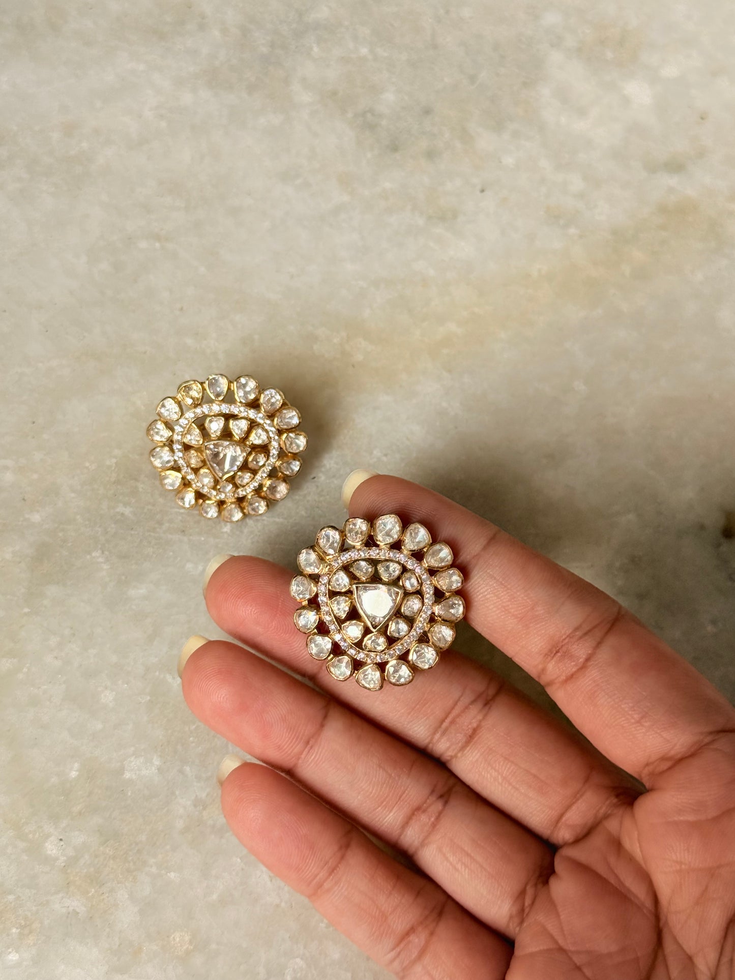925 Sterling Silver Gold Plated Antique Moissanite Polki Earrings held in hand on marble background.