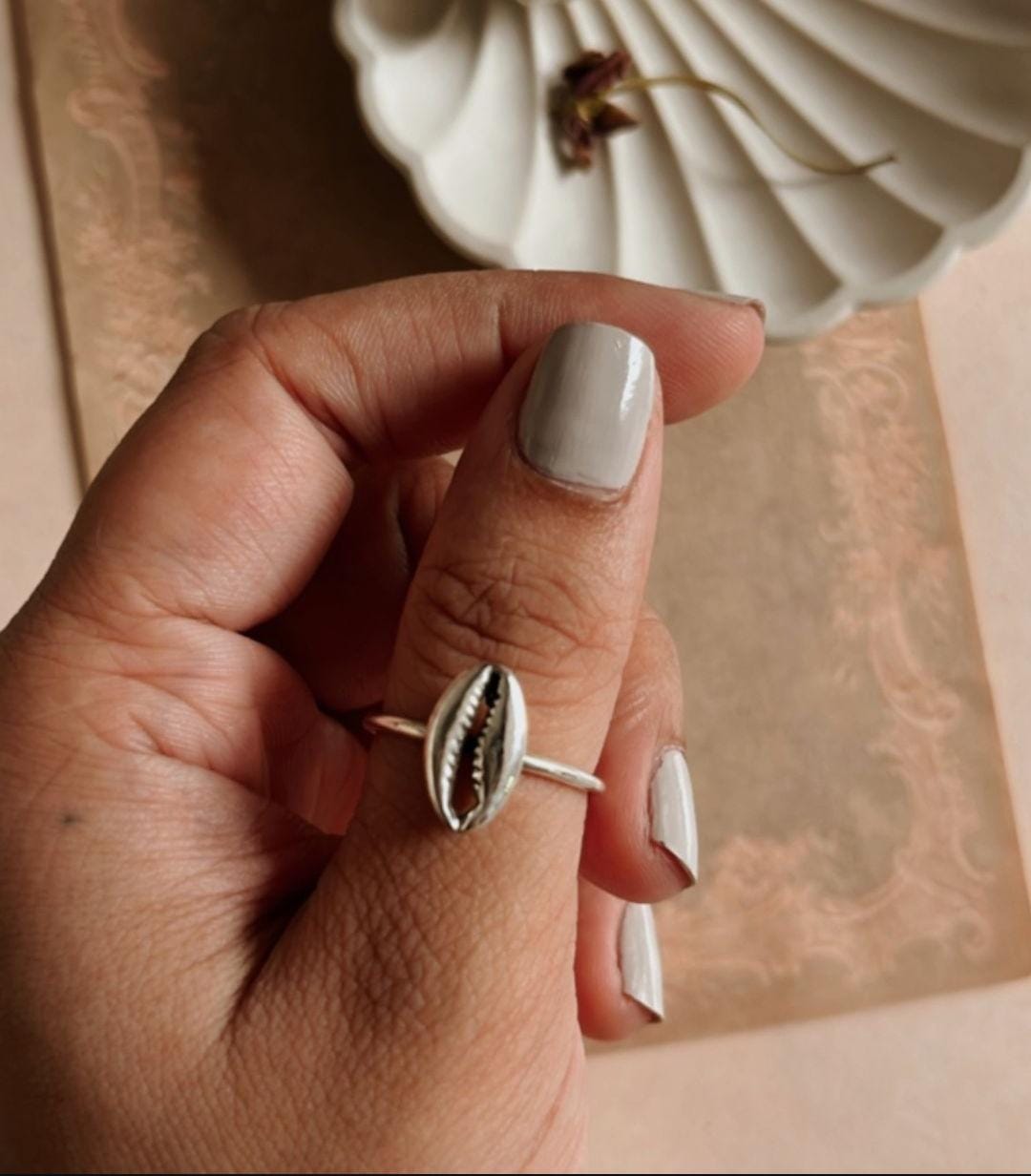 Handcrafted silver ring featuring a natural cowrie seashell design