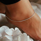 Close-up of classic snake chain anklet in polished pure silver