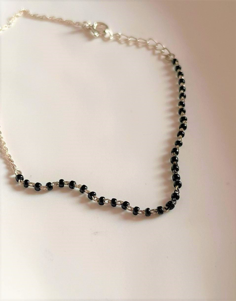 Elegant Silver Anklet with Black Beads and Half Chain Design