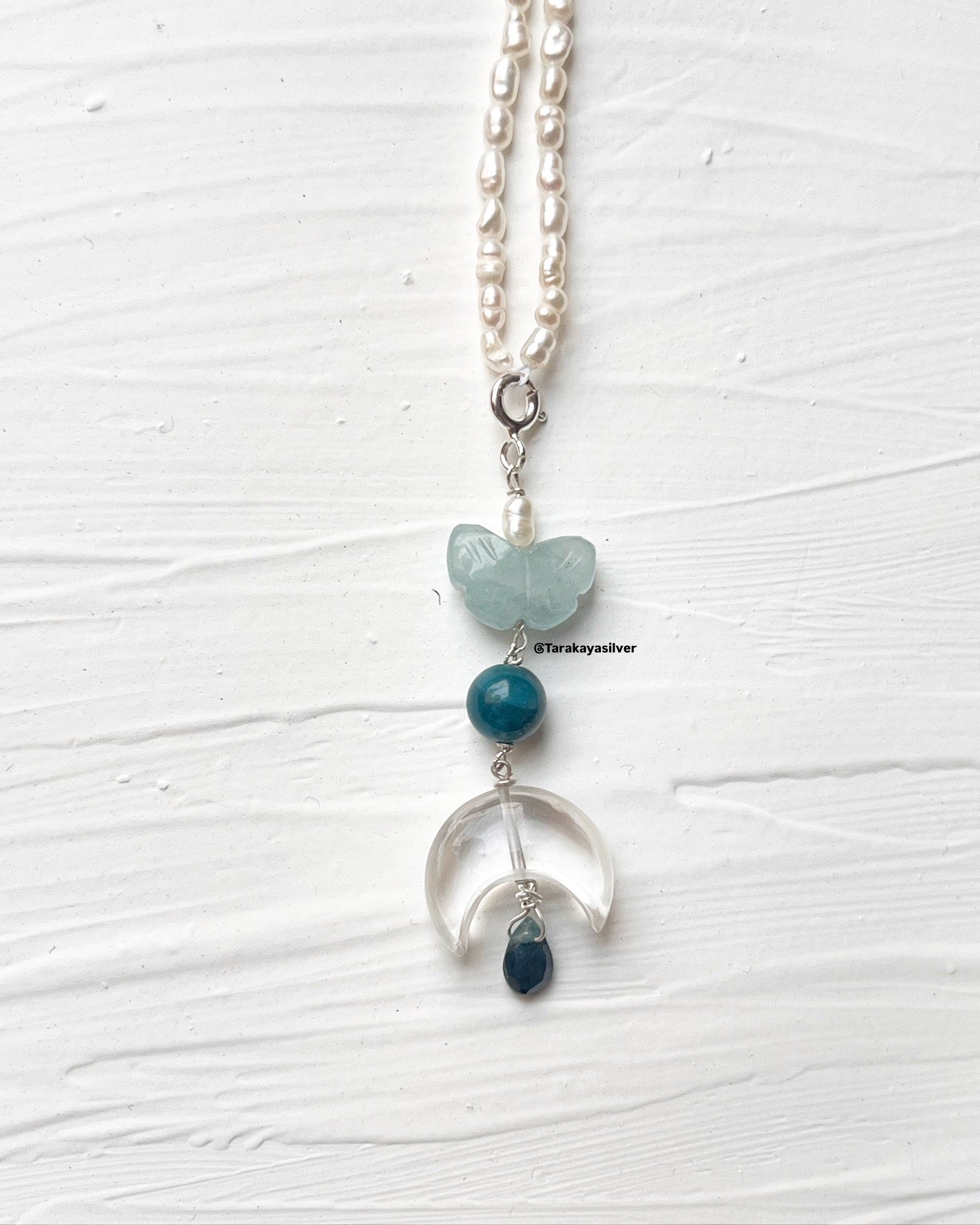 Handmade aquamarine butterfly crystal pendant close-up  