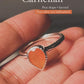 Close-up of carnelian pear stone in a silver ring setting