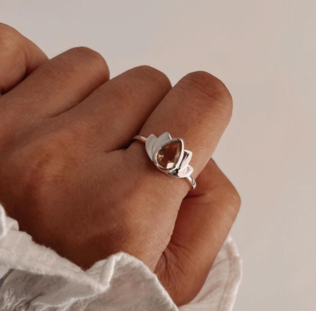 Close-up of citrine divine lotus ring with detailed silver petals