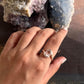 Charming rose quartz oval ring with cross-patterned silver band