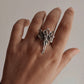 Celestial adjustable silver ring featuring an angel wing design.
