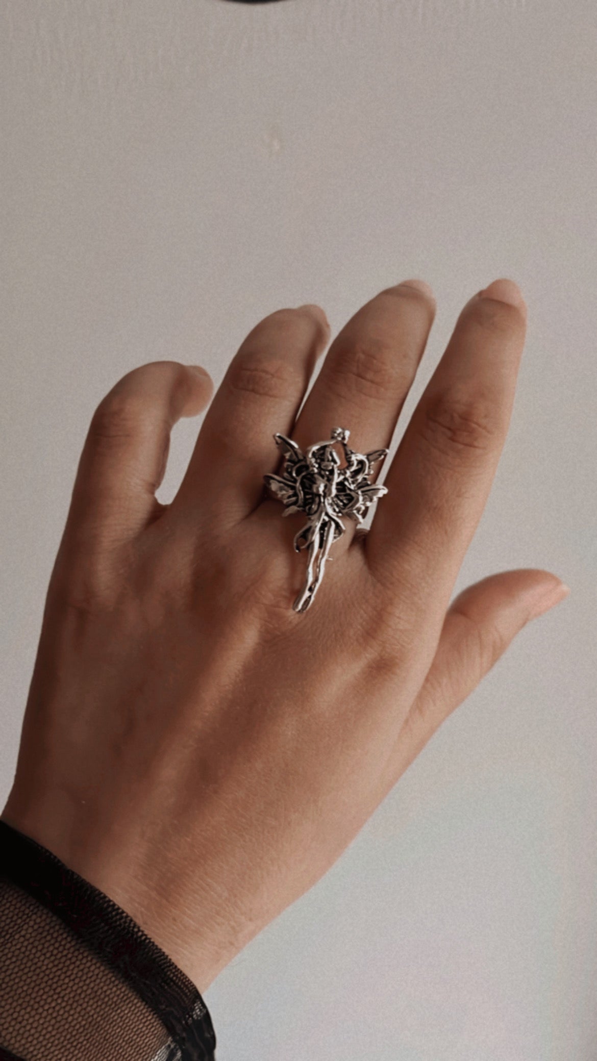 Celestial adjustable silver ring featuring an angel wing design.