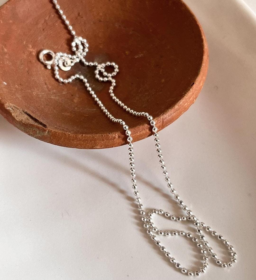 Close-up of dot ball silver chain with smooth, polished spheres