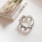 Vintage-style silver ring with vine and leaf details