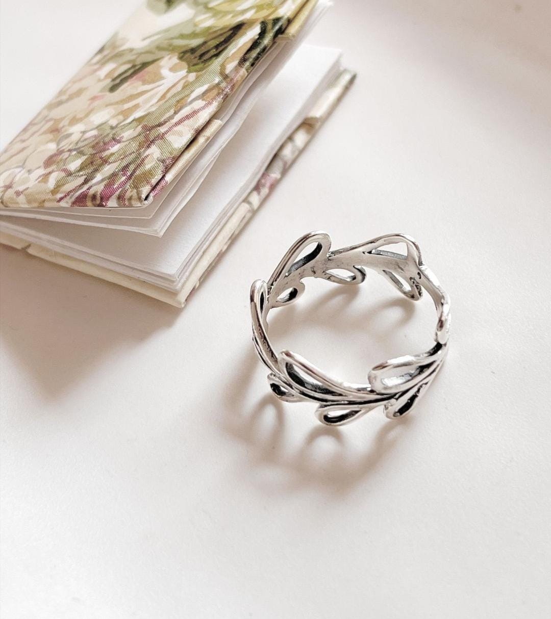 Vintage-style silver ring with vine and leaf details