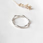 Sterling silver ring with wavy band design