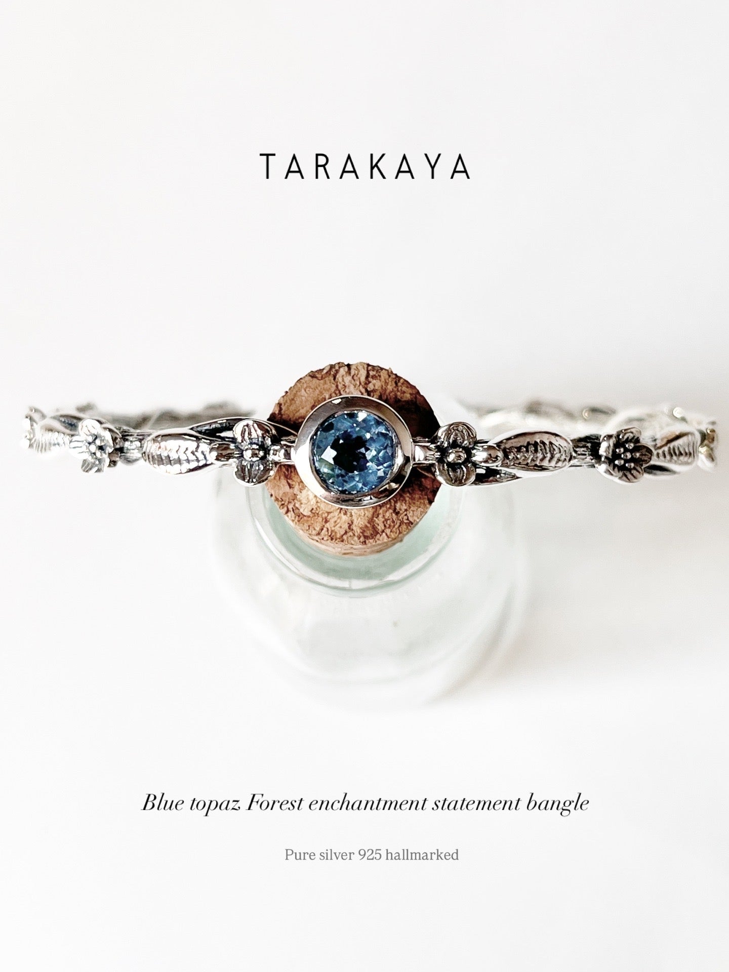Elegant forest-inspired blue topaz statement bangle in 925 silver