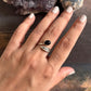 Stylish black onyx and feather design adjustable silver ring for a bold statement.