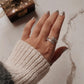 Timeless feather wrap silver ring featuring a delicate, adjustable band