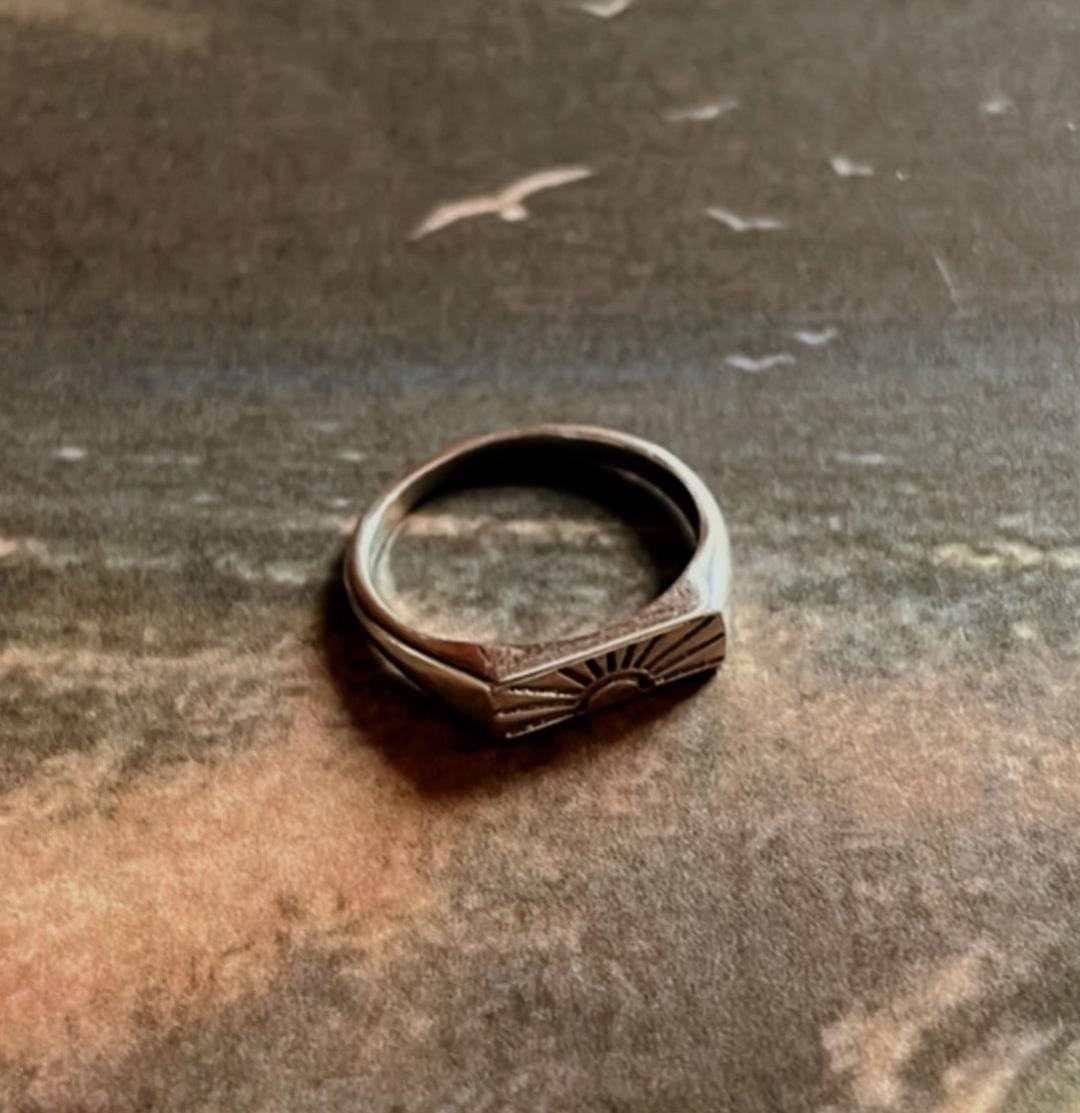 Sun engraved signet ring with intricate details