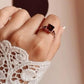 Vintage silver ring with intricate details and square-cut garnet