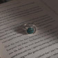 Close-up of copper turquoise moon stone in an adjustable silver ring